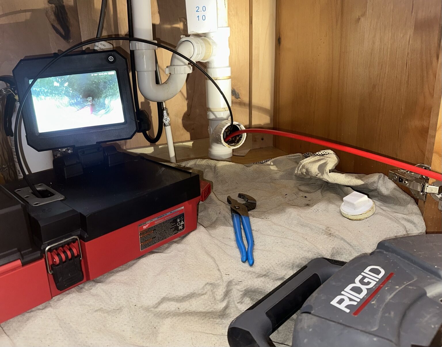 Drain camera inspection beneath a kitchen sink